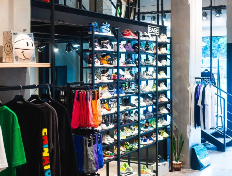 Inside a clothing boutique with garments on rails